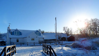 The cottage covered in snow